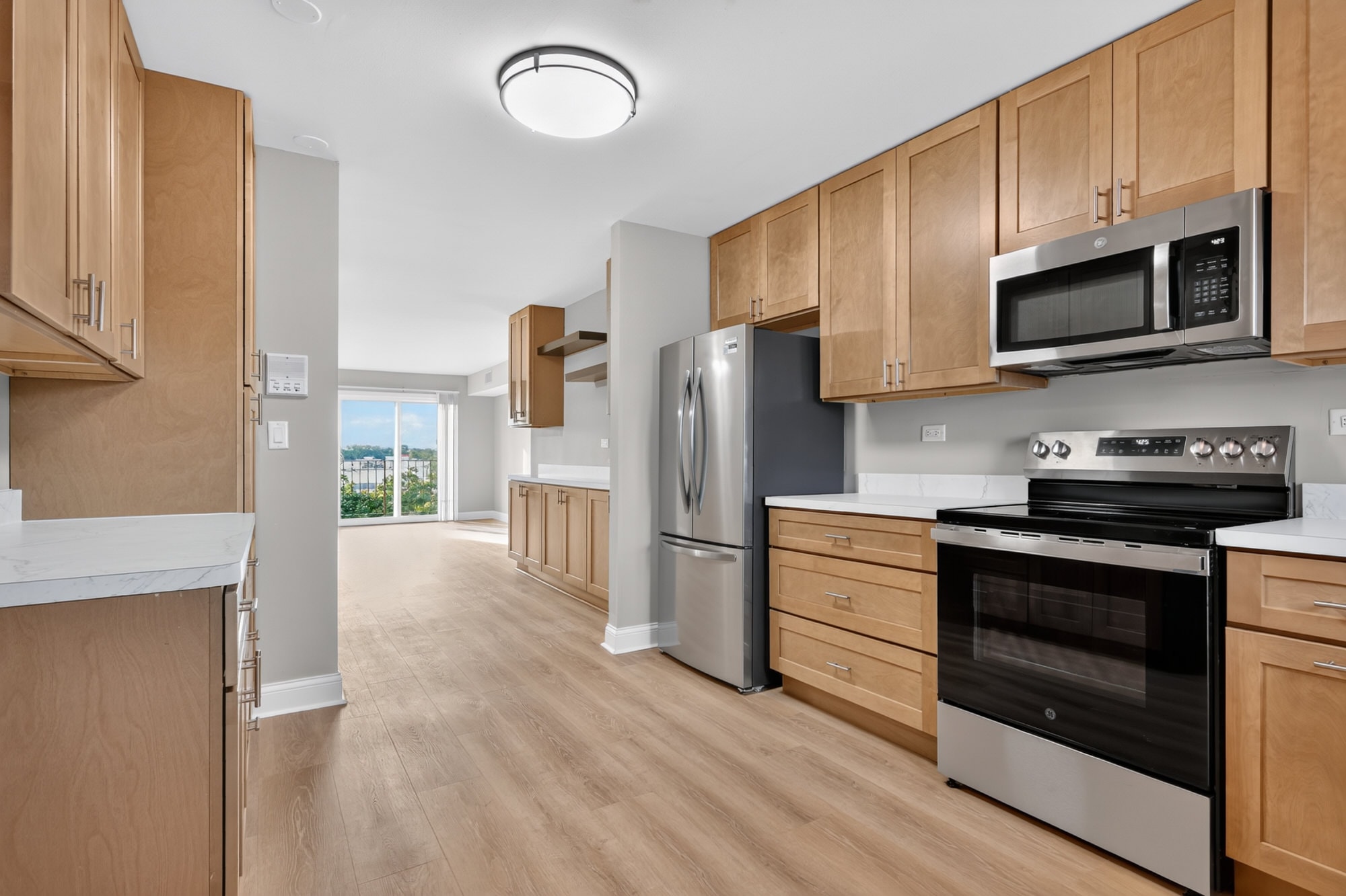 A kitchen with wooden cabinets and stainless steel appliances.