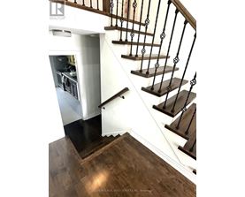 A staircase with a black railing and wooden steps.