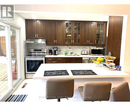 A modern kitchen with wooden cabinets and stainless steel appliances.
