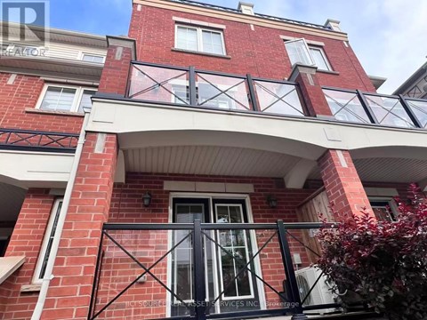 A red brick building with a black metal railing.