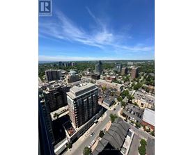 A cityscape with a clear blue sky and buildings of various heights.