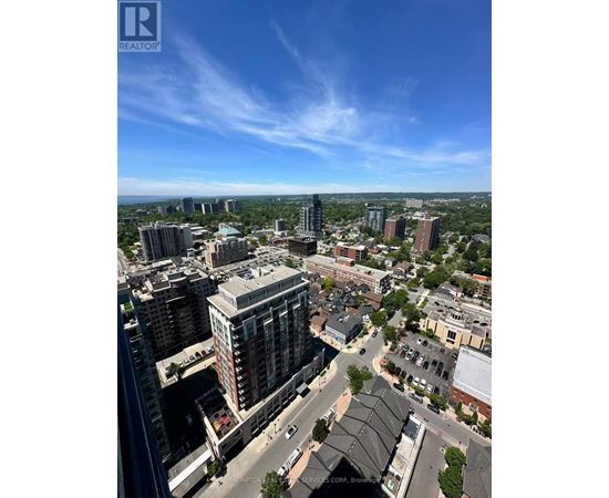 A cityscape with a clear blue sky and buildings of various heights.