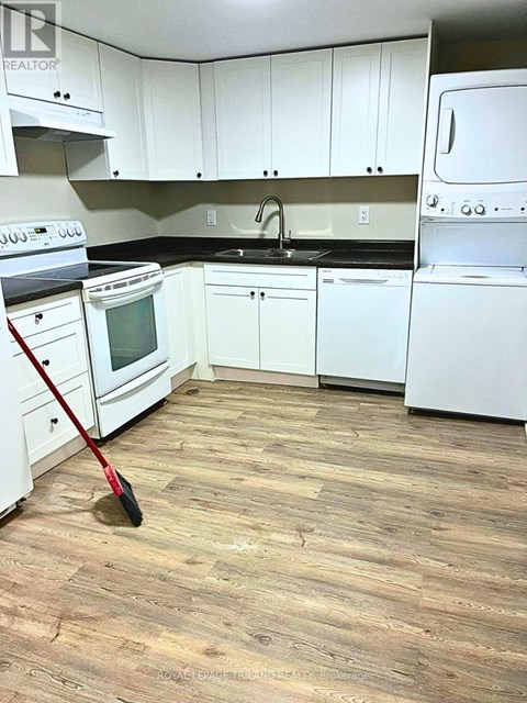 A kitchen with white appliances and cabinets.