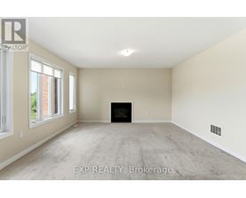 A spacious living room with a fireplace and large windows.