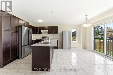 A kitchen with dark brown cabinets and a white countertop.