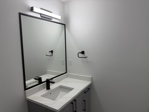 A bathroom with a sink and mirror.