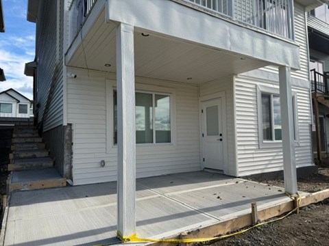 A house with a white door and windows is shown.