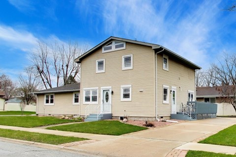 A two-story house with a front porch and a garage.