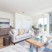 A living room with a grey couch and a wooden coffee table.
