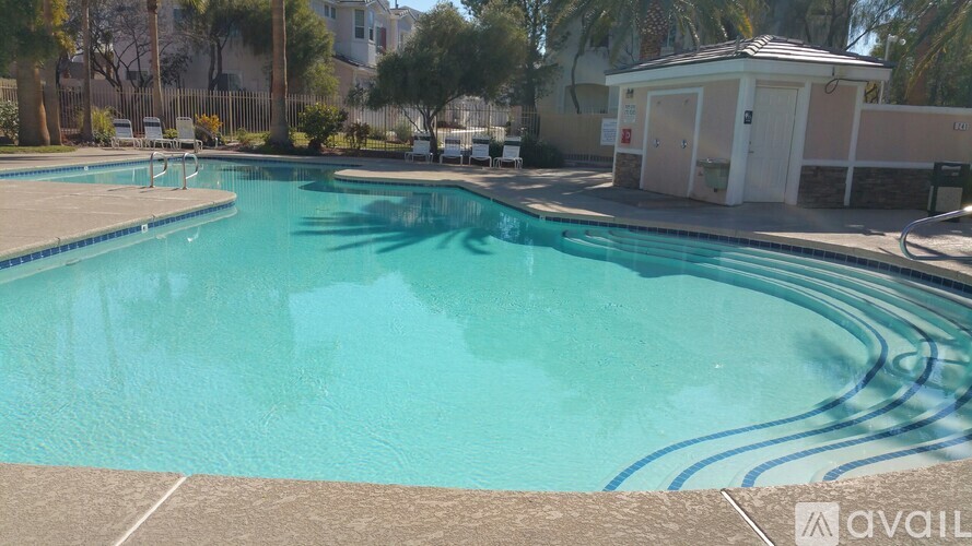 A swimming pool with a small building next to it.