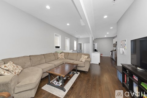 A living room with a large couch and a coffee table.