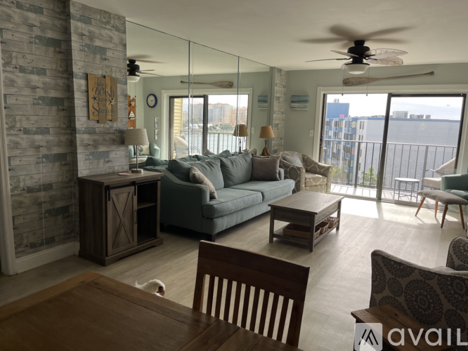 A living room with a grey couch and a wooden table.