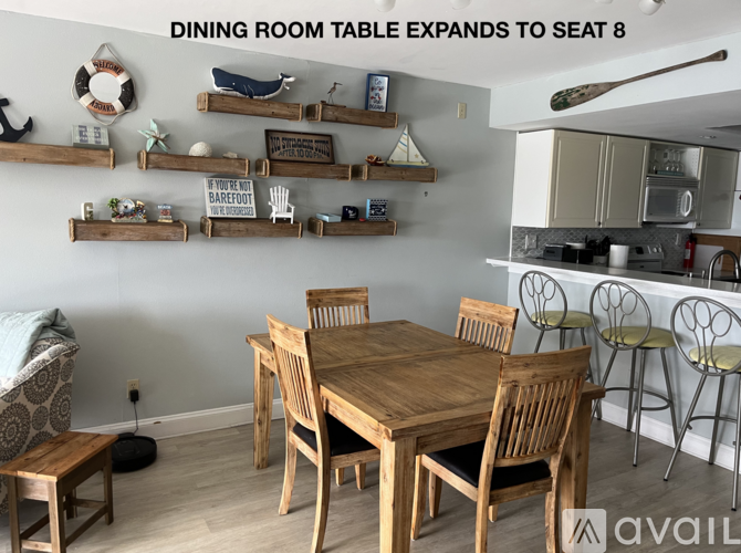 A dining room with a table that can expand to seat 8 people.