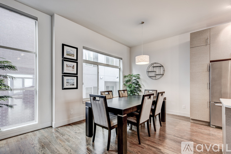 A dining room with a wooden table and chairs.