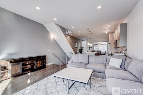 A modern living room with a grey sofa and a coffee table.