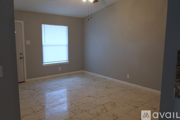A room with a marble floor and a window.
