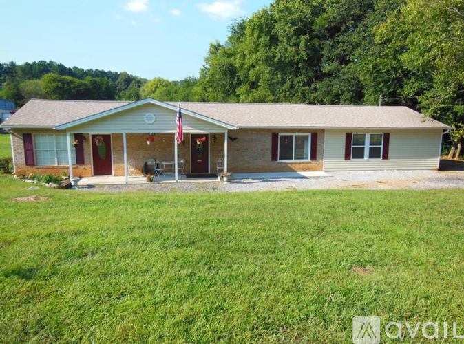 A house with a flag on the front porch is for sale.