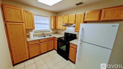 A kitchen with wooden cabinets and a white refrigerator.