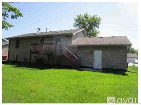 A house with a green lawn in front of it.