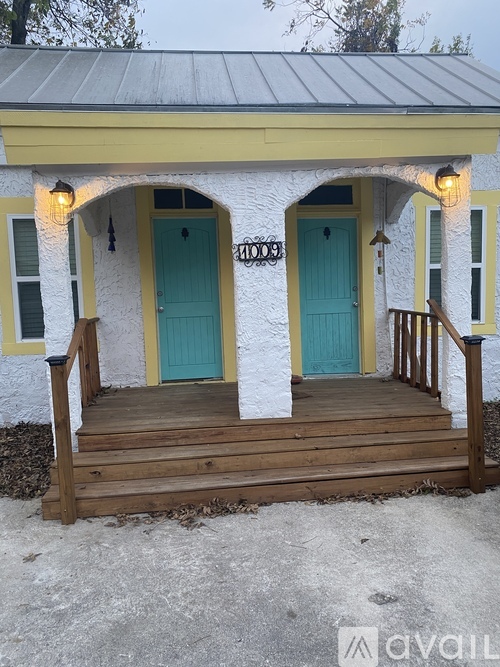 A small house with a porch and two doors.