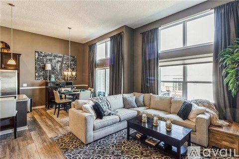 A living room with a grey couch and a coffee table.