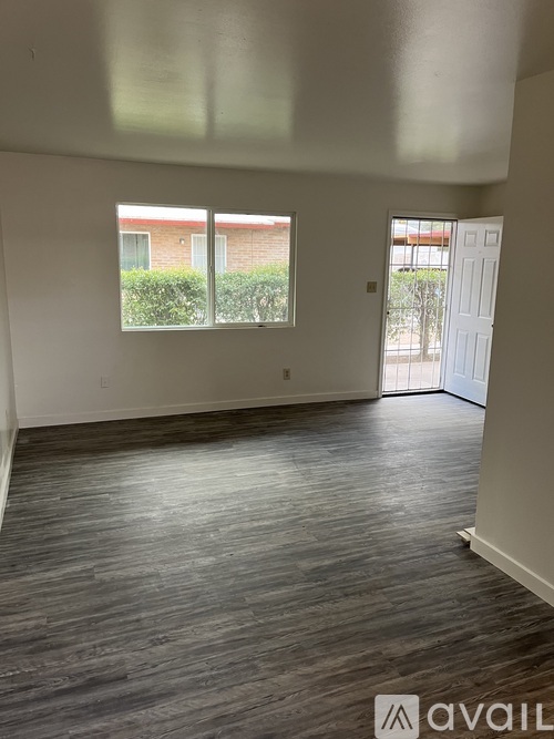 A room with a window and a door is available for rent.