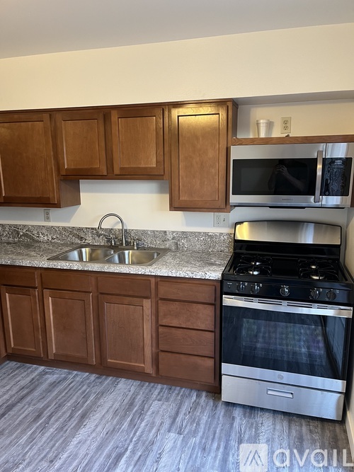A kitchen with a stove and cabinets.