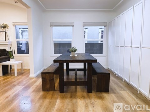 A modern living room with a wooden table and benches.