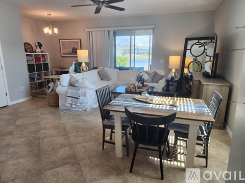A living room with a dining table and chairs.
