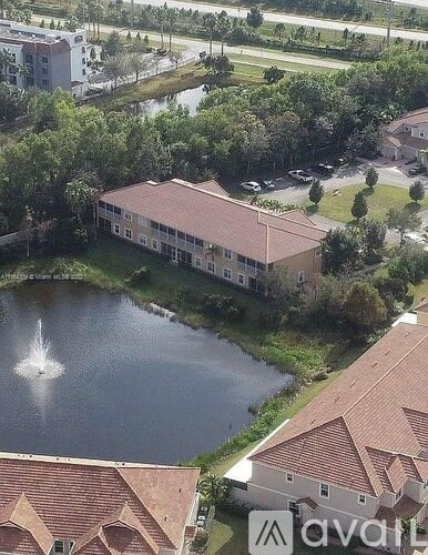 A bird's eye view of a building with a fountain in front of it.