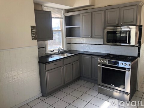 A kitchen with a black oven and microwave.