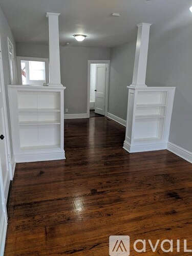 A room with wooden floors and white trim.