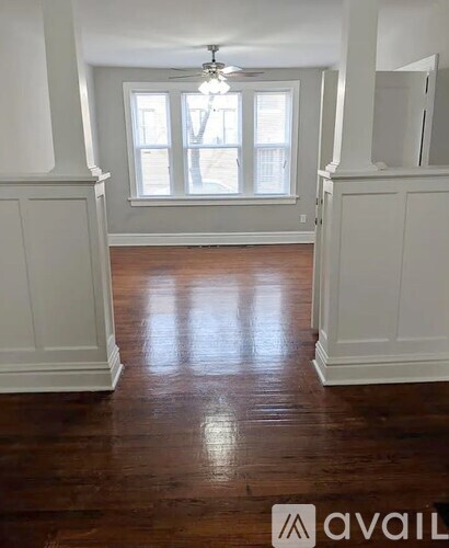A room with wooden floors and white walls.