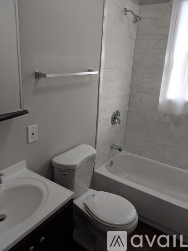 A bathroom with a toilet, sink, and bathtub.