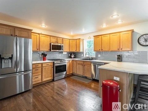 A kitchen with wooden cabinets and stainless steel appliances.