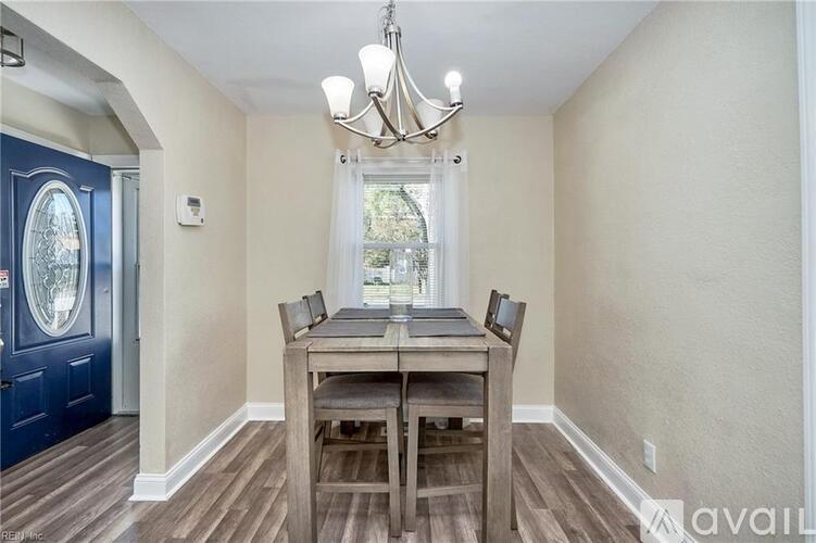 A dining room with a wooden table and chairs.