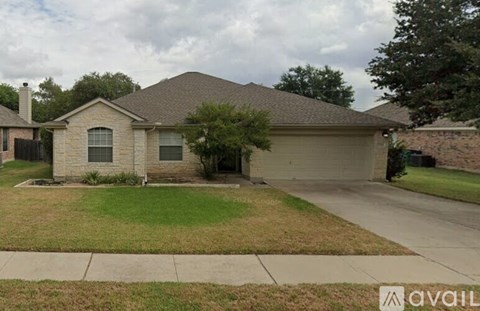 A house with a brown roof and a grey garage door.