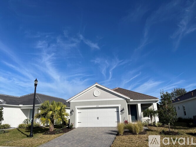 A house with a driveway and garage in front of it.