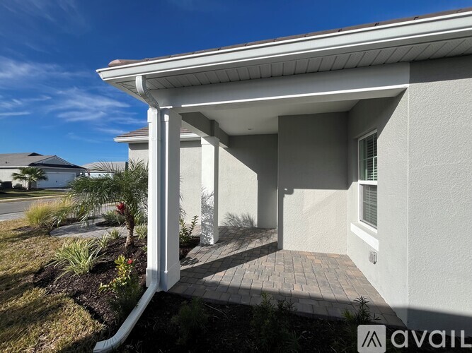 A house with a white exterior and a covered patio area.
