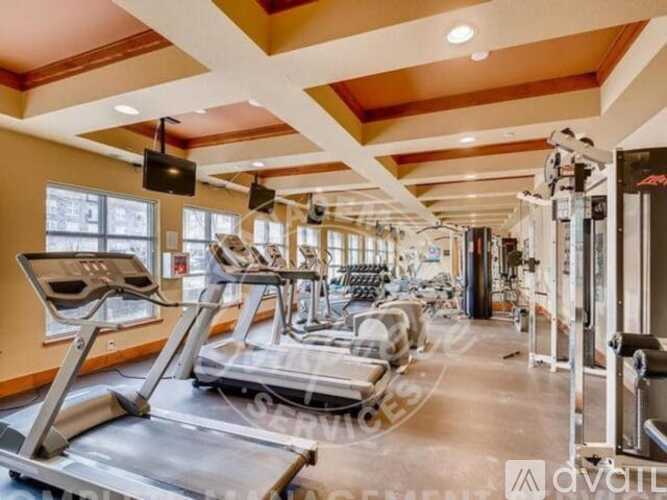 A gym with treadmills, elliptical machines, and other exercise equipment.