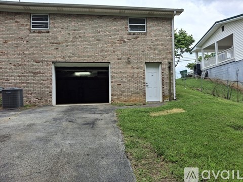 A brick building with a garage door and a white door.