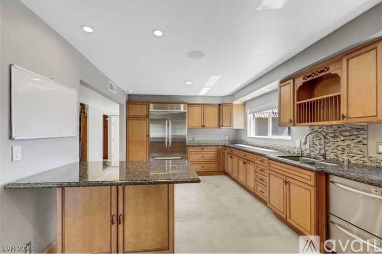 A kitchen with wooden cabinets and a granite countertop.