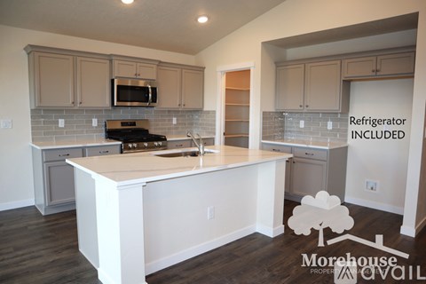 A kitchen with a refrigerator included.