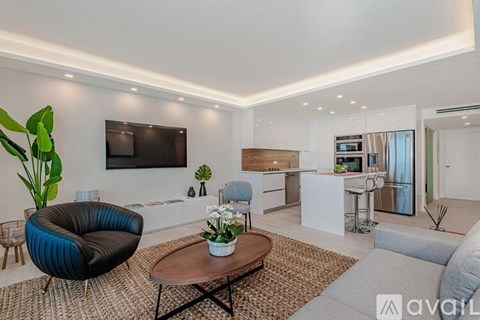 A modern living room with a black chair and a wooden coffee table.
