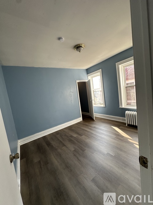 A room with blue walls and wooden flooring.