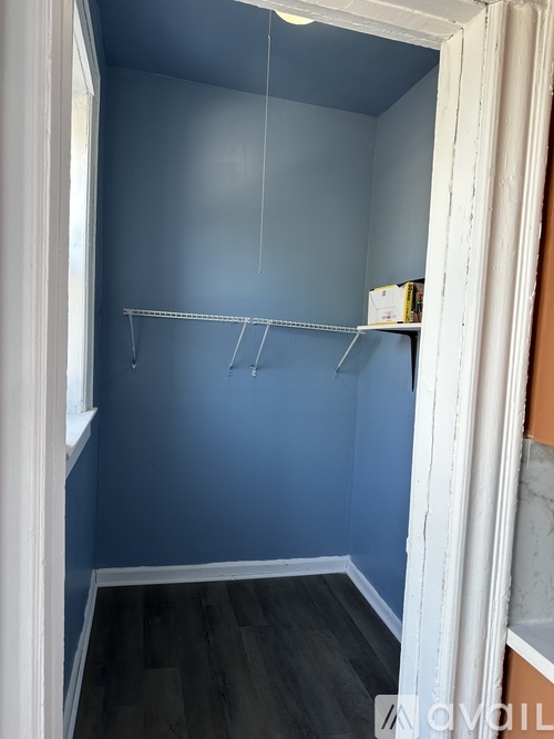 A room with blue walls and a white door.