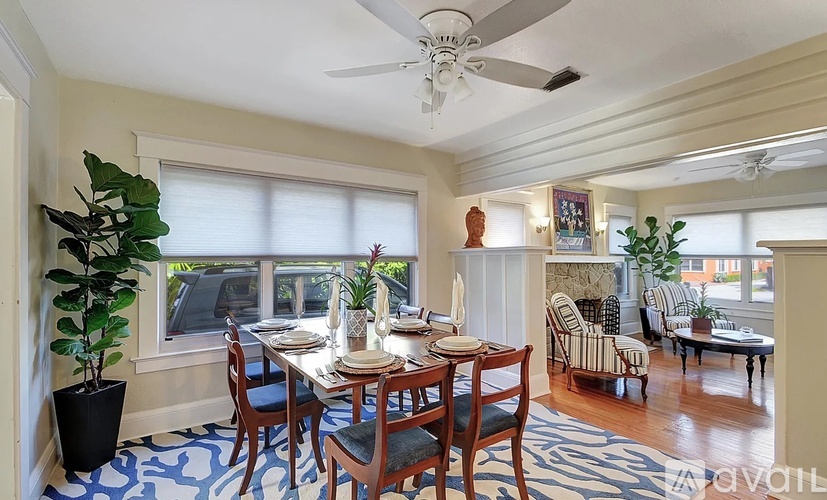 A dining room with a table set for a meal.