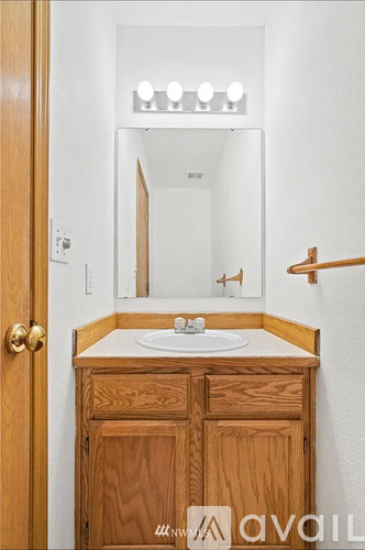 A bathroom with a sink and a mirror.