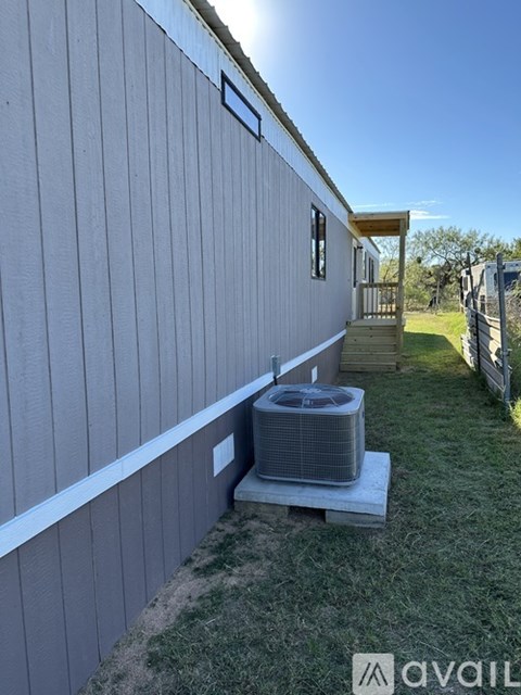 A wall with a window and a vent on it.