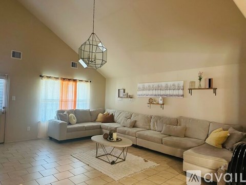 A living room with a grey sofa and a coffee table.